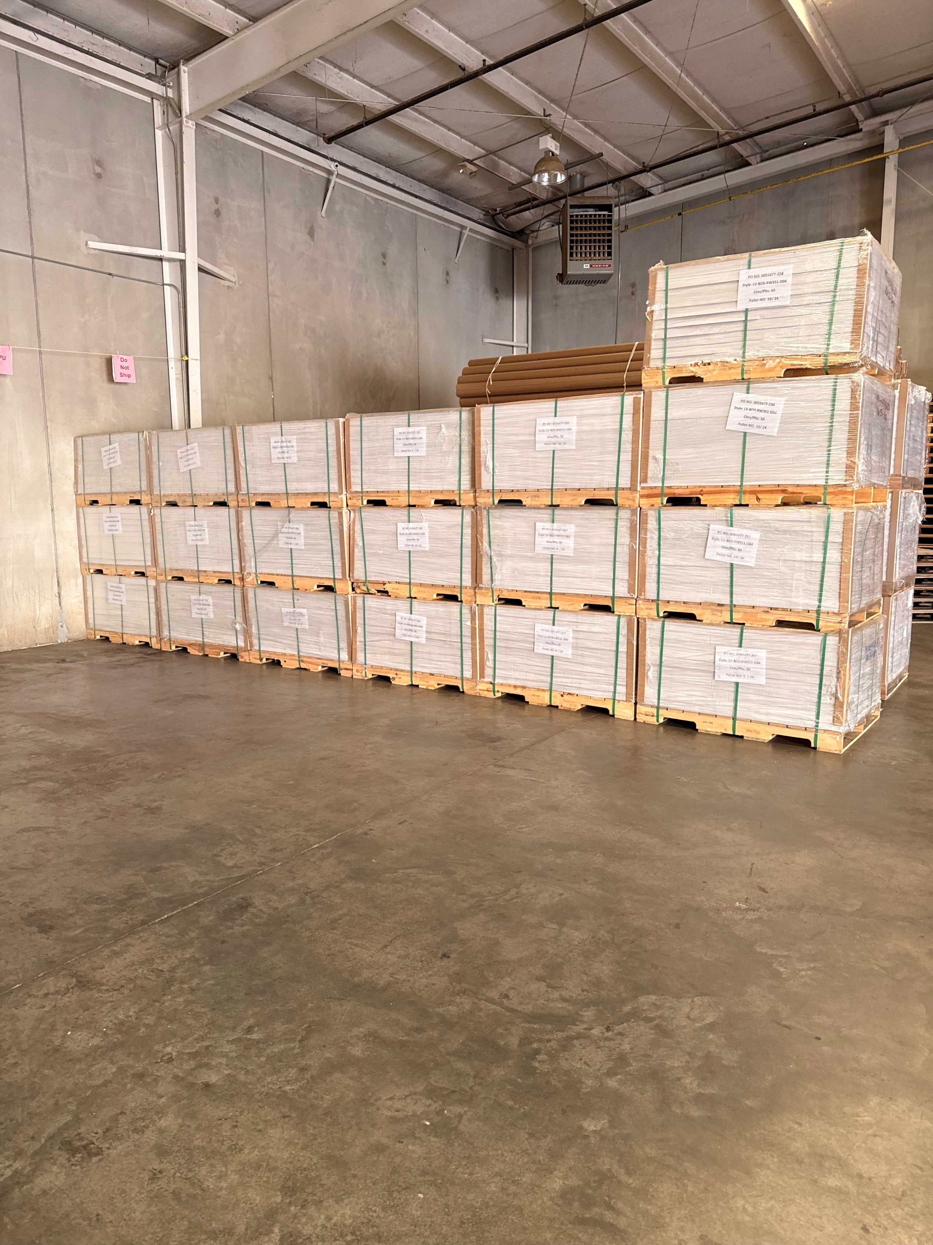 Flooring pallets stacked in warehouse